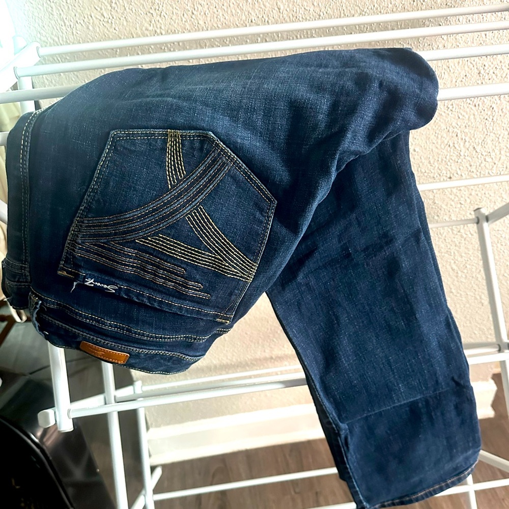 Excellent condition. Dark blue and stretchy denim.